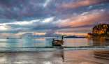 Beautiful early morning view of Railay Beach with a tail boat