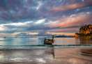 Beautiful early morning view of Railay Beach with a tail boat