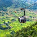 SA PA, VIETNAM - Aug 12, 2019 : The world's longest electric cable car go to Fan Si Pan or Pang Xi Pang mountain peak the highest mountain of Indochina with beautiful Rice field at SA PA, Lao Cai, Vietnam